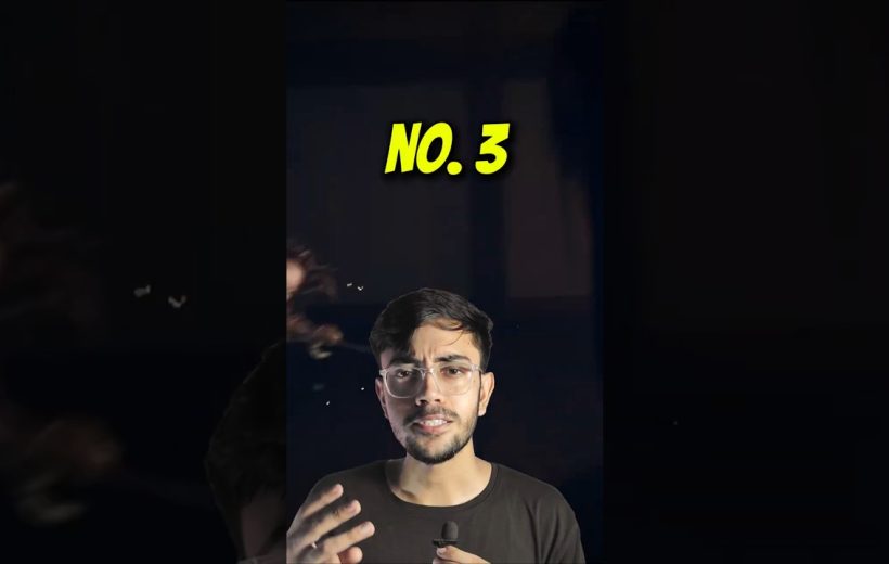 Young man wearing glasses speaking into a small microphone with "No. 3" text above