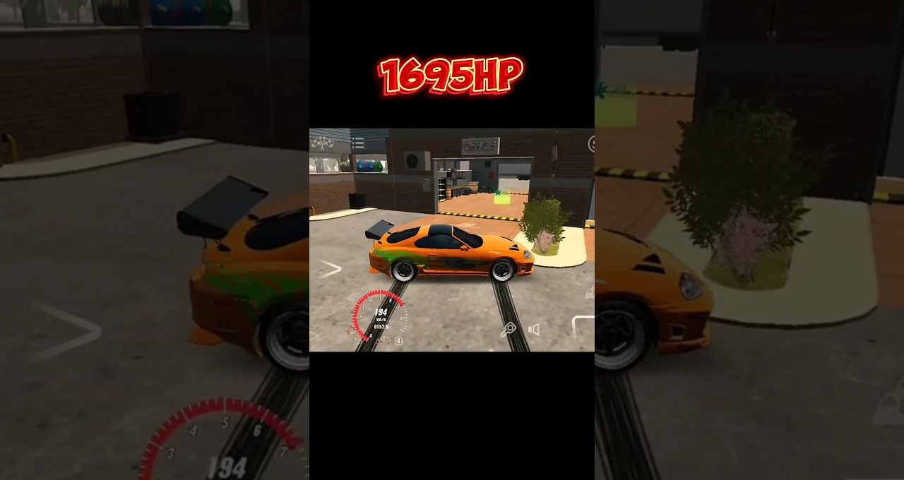 Orange sports car with green accents parked in a garage area, speed HUD visible