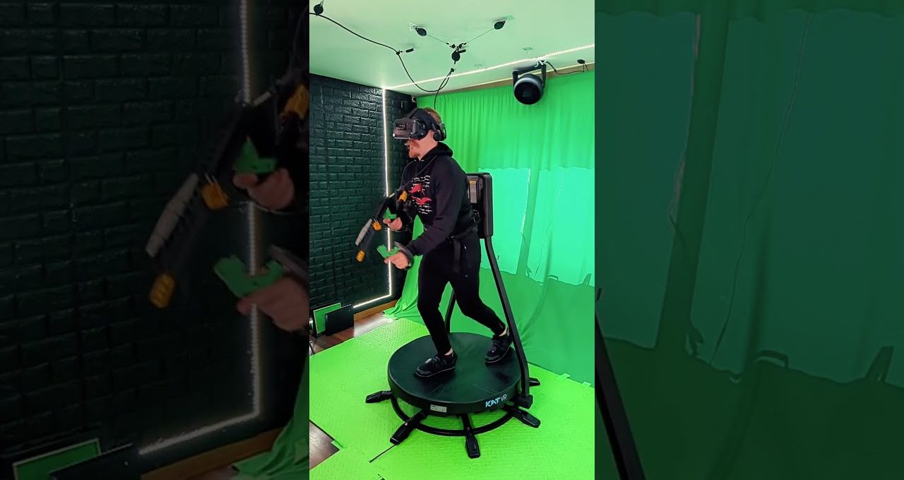 Person wearing VR headset and holding controllers on an omnidirectional VR treadmill in studio