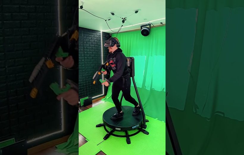 Person wearing VR headset and holding controllers on an omnidirectional VR treadmill in studio