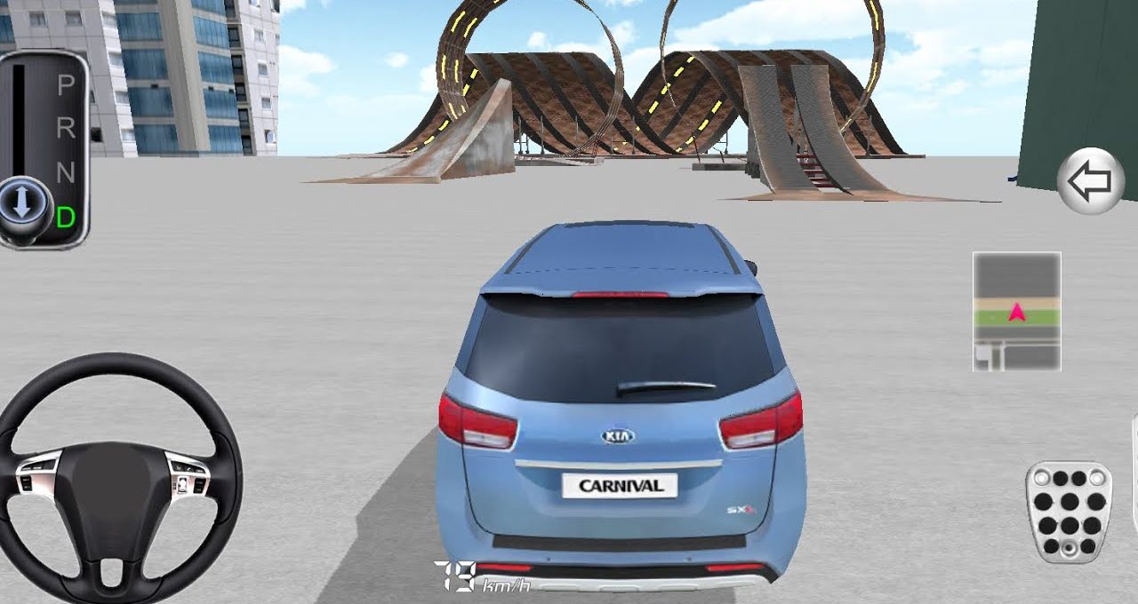 Blue Kia Carnival car facing large stunt ramps in an empty urban parking area