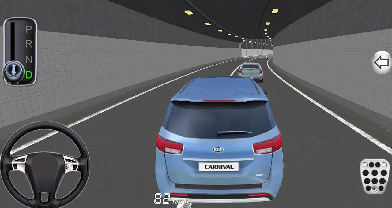 Blue Kia Carnival minivan driving through a lit tunnel behind another car