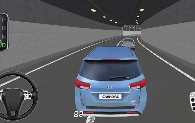 Blue Kia Carnival minivan driving through a lit tunnel behind another car