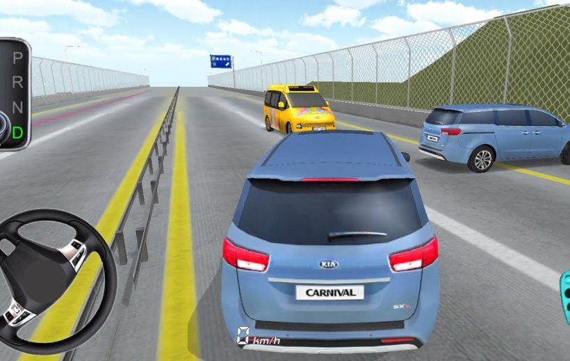 Rear view of a blue Kia Carnival driving on a divided highway with traffic