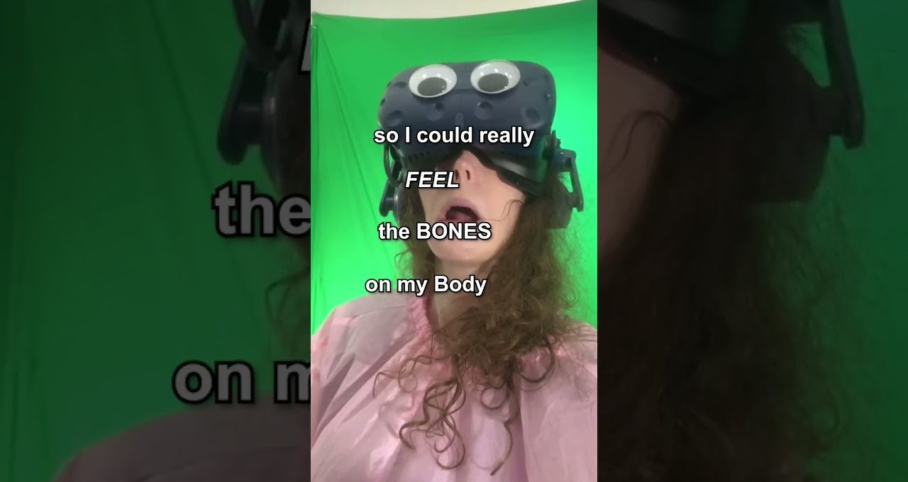 Person wearing VR headset with googly eyes, mouth open against a green screen backdrop