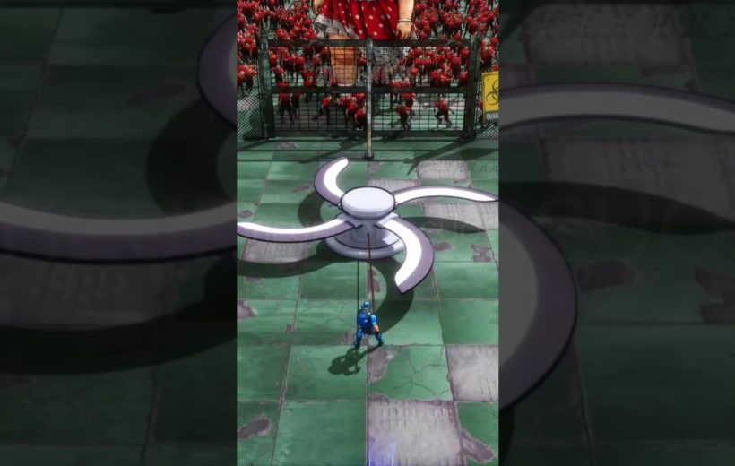 Small blue-suited figure pulling a giant ceiling fan blade in fenced arena