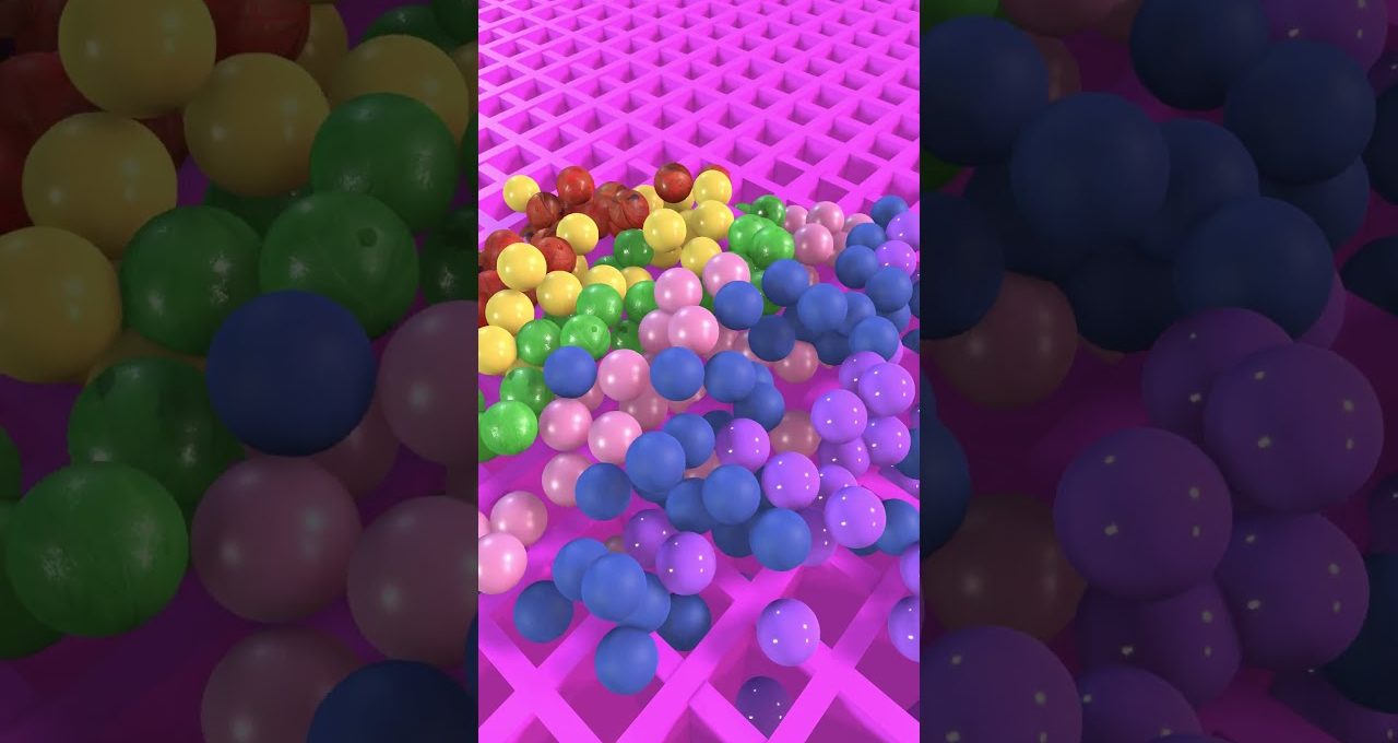 Colorful plastic balls clustered on a pink grid surface, assorted sizes and hues