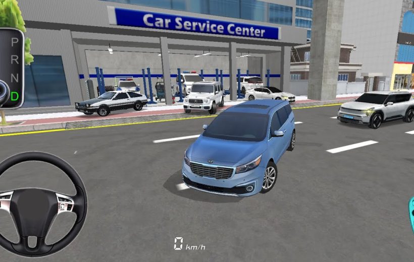 Blue minivan stopped on city street in front of a car service center.