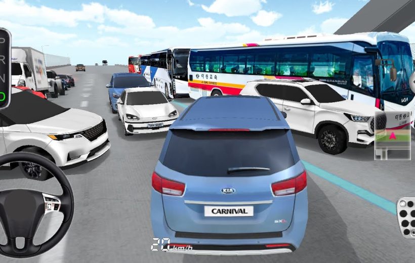 Blue Kia Carnival minivan navigating heavy traffic between buses and cars on highway