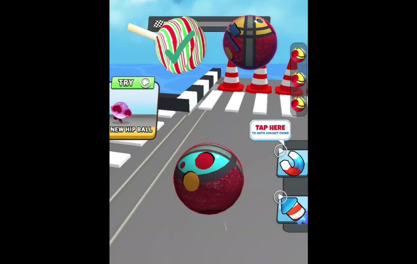 Colorful rolling ball approaching finish line with traffic cones in a mobile game.
