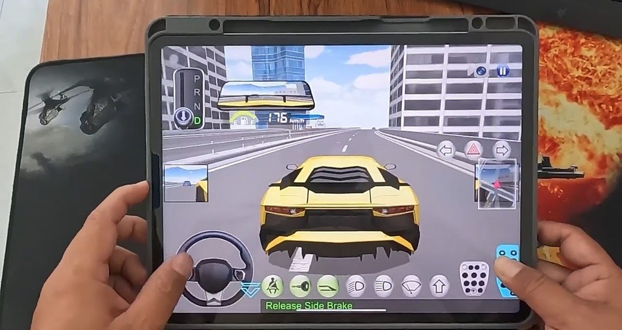 Person holding tablet playing a racing game with a yellow sports car on highway