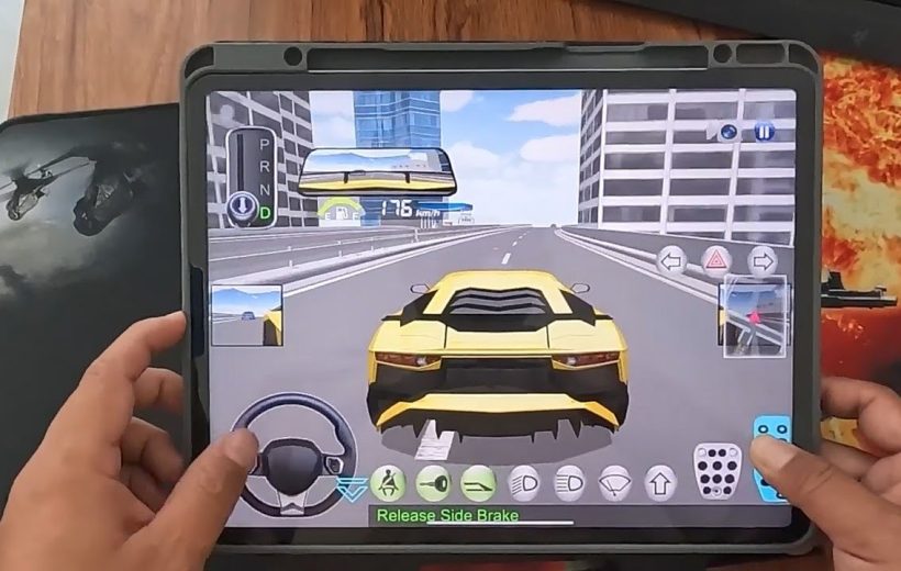 Person holding tablet playing a racing game with a yellow sports car on highway