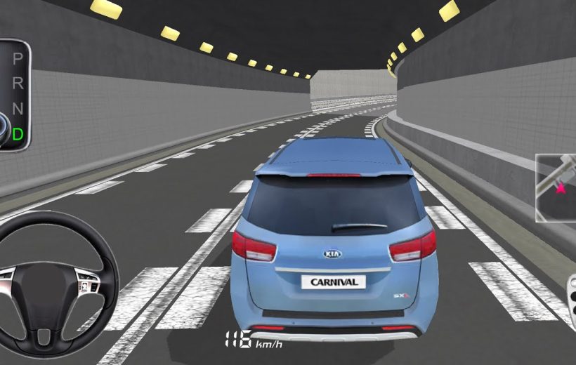 Blue Kia Carnival driving through a lit highway tunnel from third-person rear view