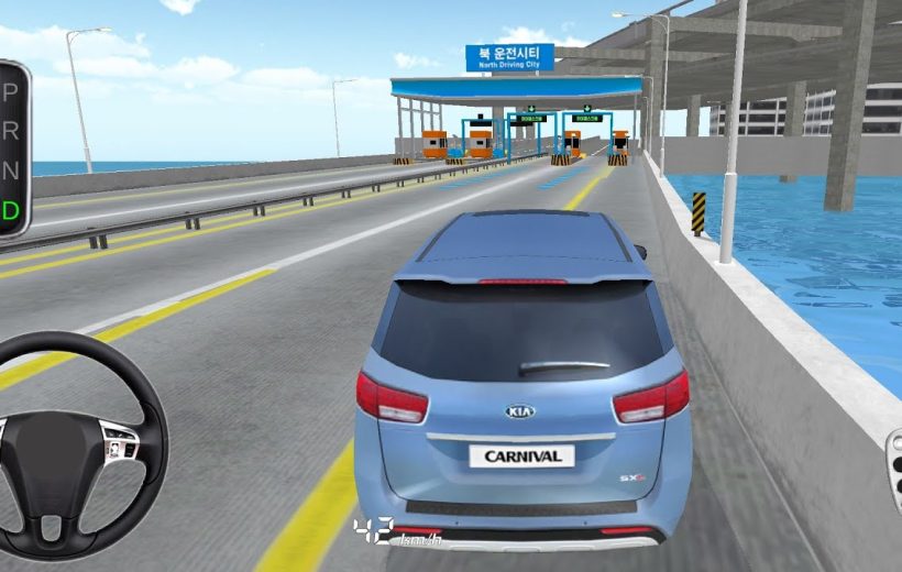 Blue Kia Carnival driving toward toll booths on a coastal elevated highway in simulation