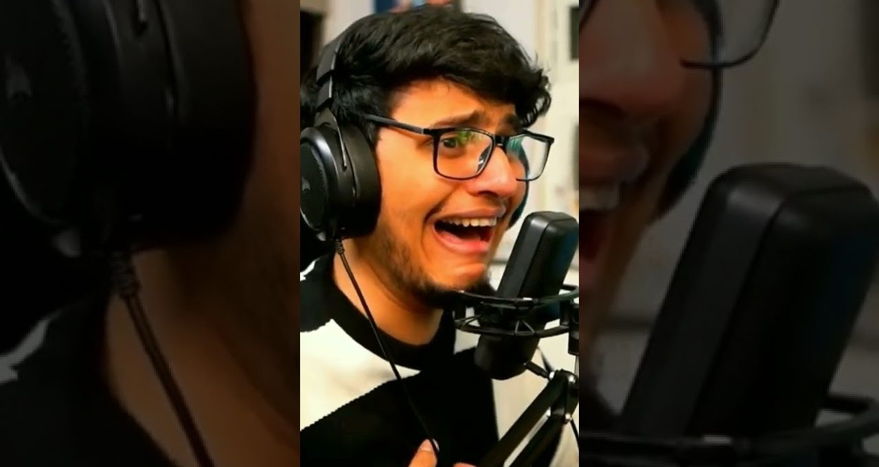 Young man wearing headphones passionately singing into a studio microphone with expressive face