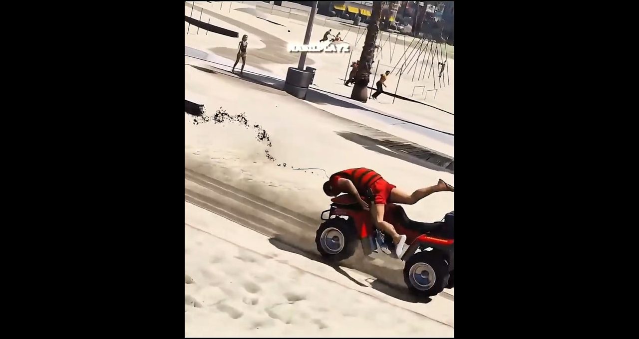 Person in red shirt falling off a red ATV skidding across sandy beach path