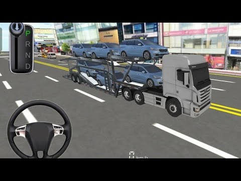 Car carrier truck hauling multiple sedans through a city street, driver view visible