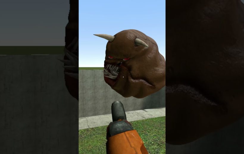 Player viewpoint aiming a pistol at a floating horned demon head with sharp teeth
