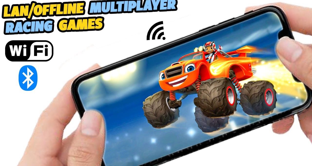 Hands holding smartphone showing colorful monster truck racing game with WiFi and Bluetooth icons
