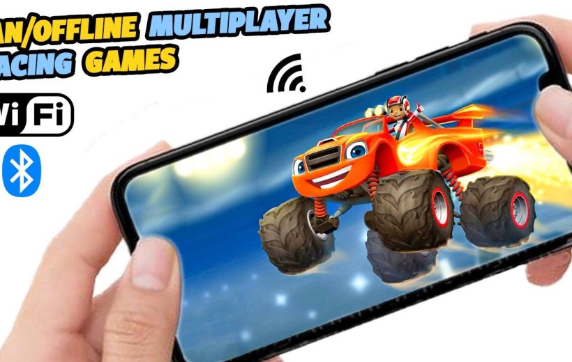 Hands holding smartphone showing colorful monster truck racing game with WiFi and Bluetooth icons