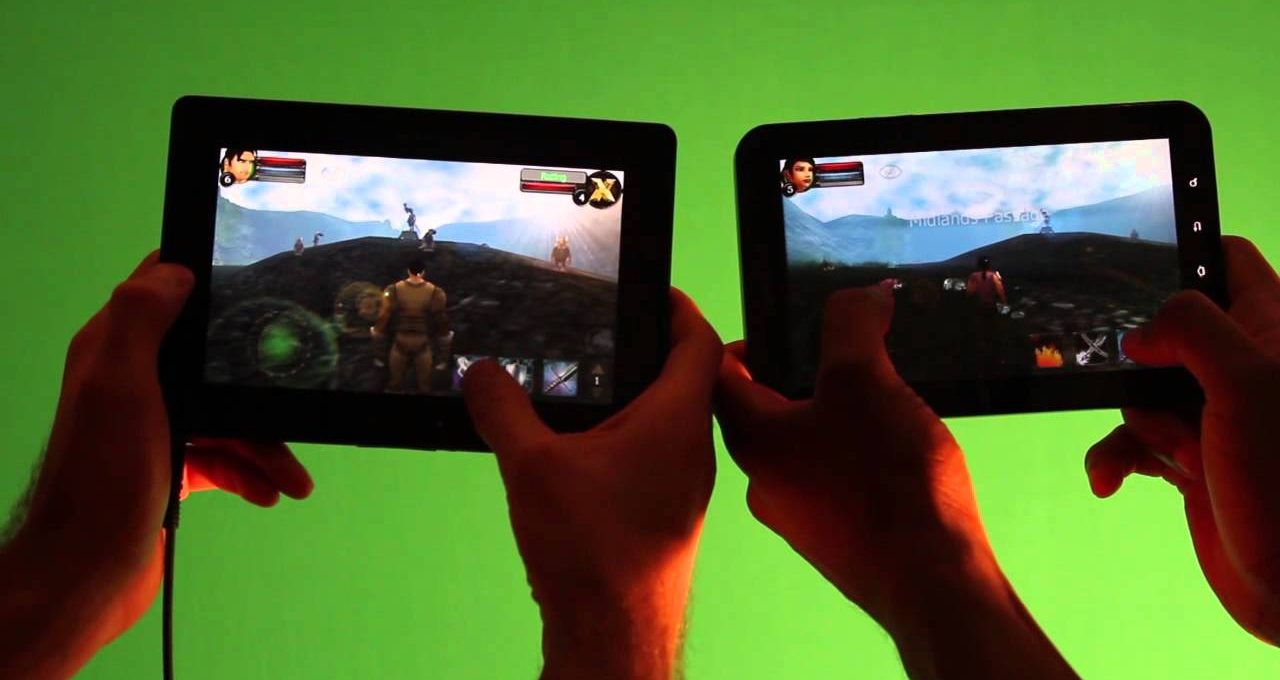 Two people holding tablets playing the same RPG game against a green background