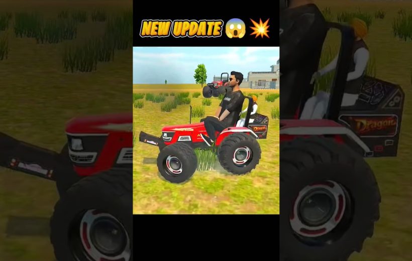 Man driving a red tractor across grassy field with buildings in background
