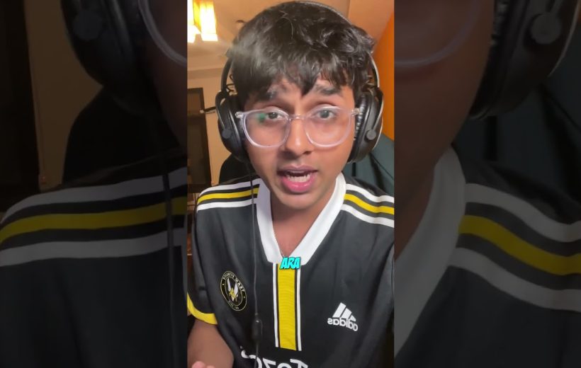 Young person wearing glasses and headphones speaking on camera in a bedroom.