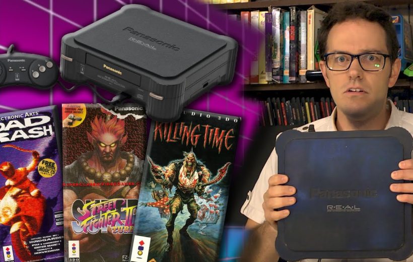 Man holding Panasonic 3DO console next to controller and vintage game boxes on shelf