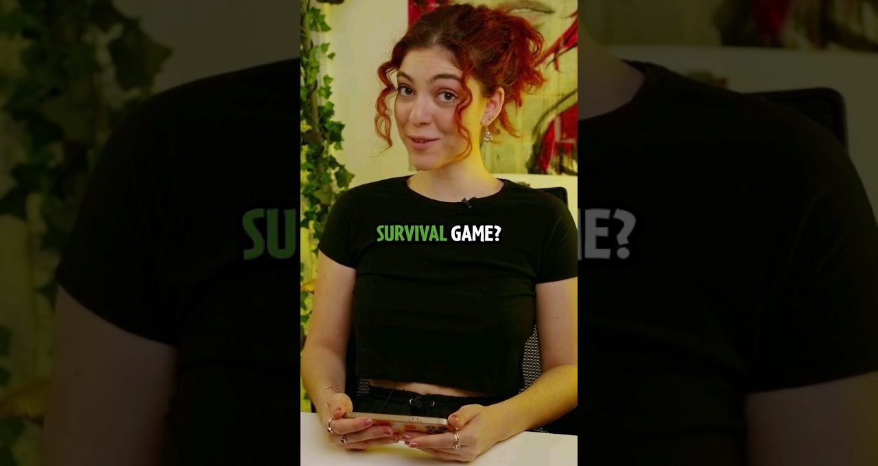 Young woman with red hair smiling while holding a smartphone, text "SURVIVAL GAME?" on shirt