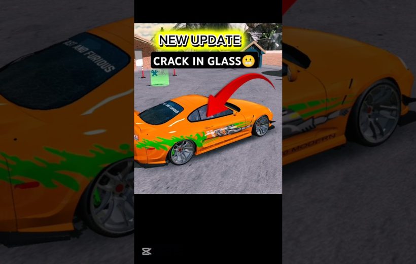 Orange sports car with green flames parked in lot, red arrow pointing to cracked glass