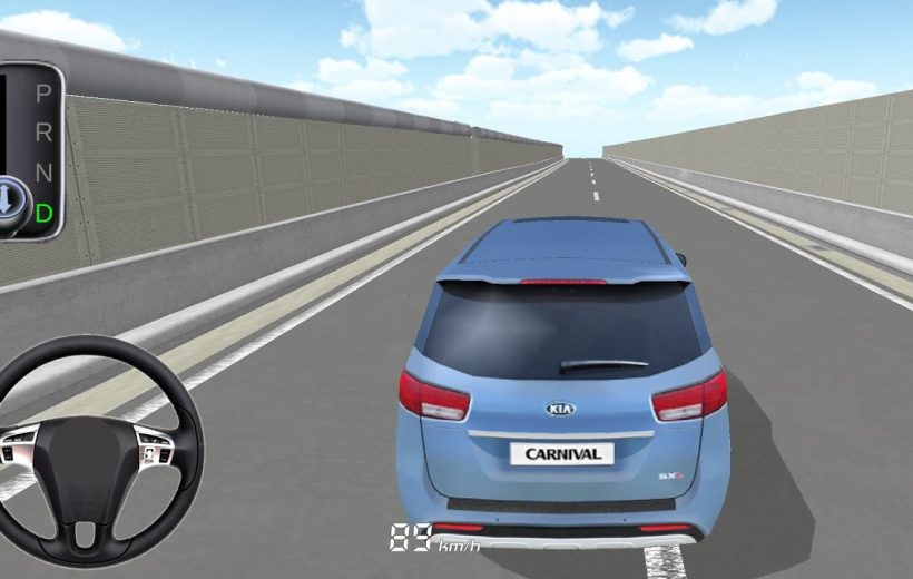 Blue Kia Carnival driving down empty elevated highway seen from rear third-person view