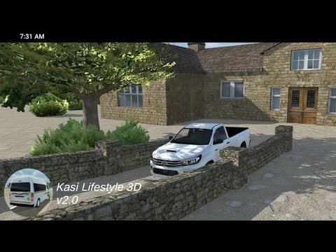 White pickup truck parked beside stone wall in a rural village courtyard.