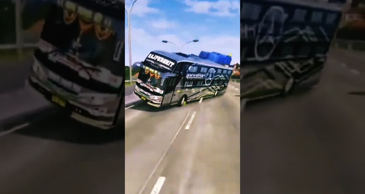 Black decorated coach bus leaning into turn on a sunny multilane highway.