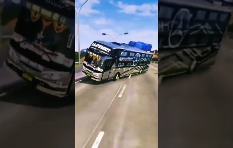 Black decorated coach bus leaning into turn on a sunny multilane highway.