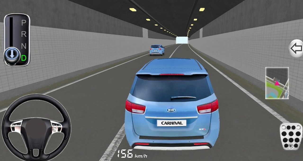 Rear view of a blue Kia Carnival driving through a lit highway tunnel.