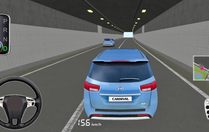 Rear view of a blue Kia Carnival driving through a lit highway tunnel.