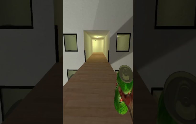 Person holding a green soda can while standing on a narrow wooden hallway bridge.