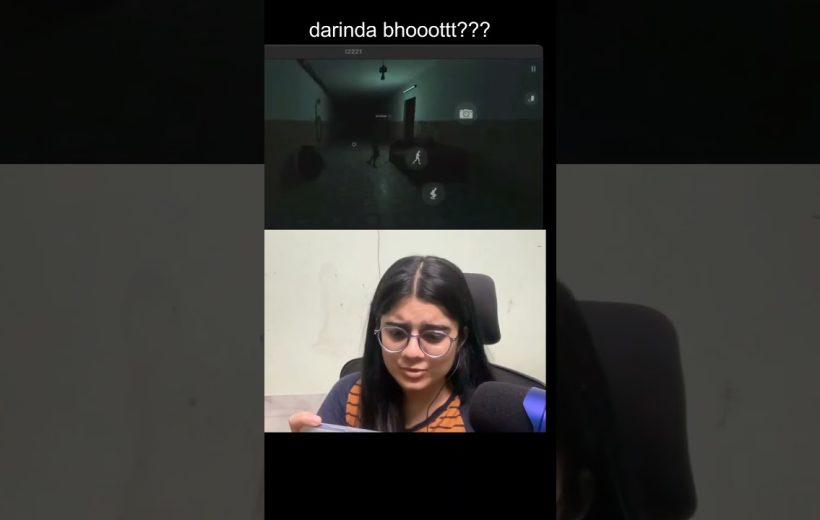 Woman wearing glasses reacting with concern while watching a dark horror game clip.