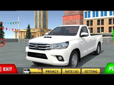 White Toyota pickup truck parked in an urban plaza with buildings in background