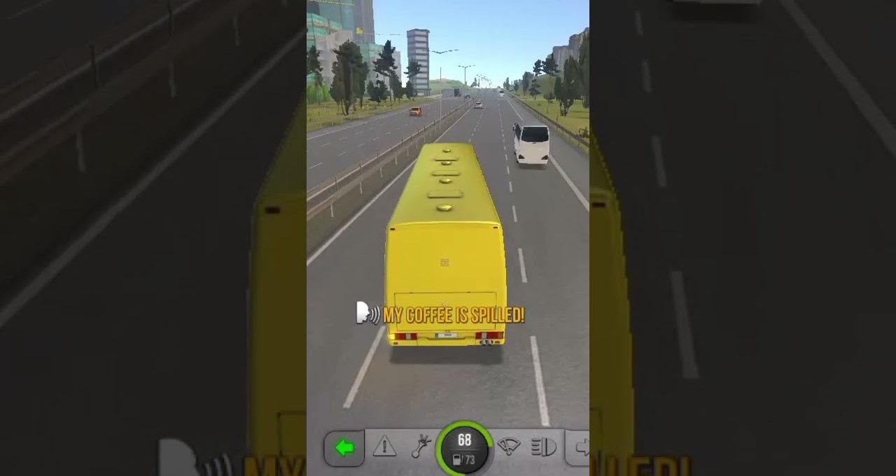 Yellow bus driving on a highway with other vehicles and city buildings ahead