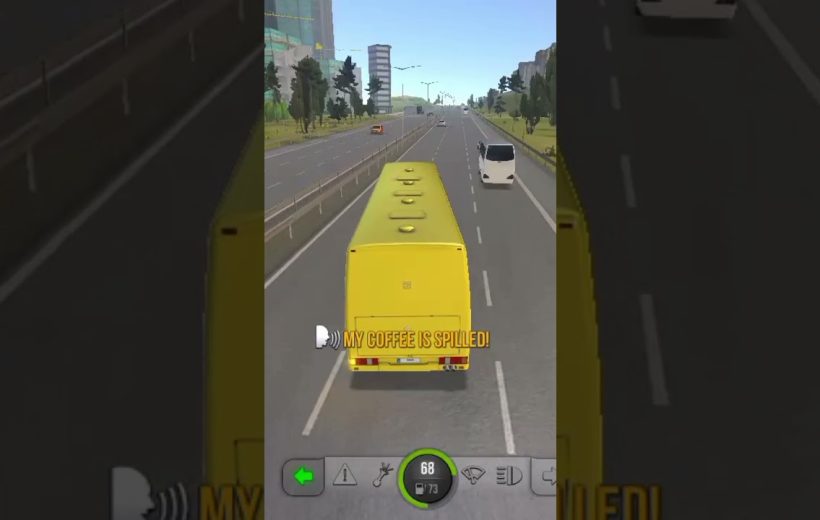 Yellow bus driving on a highway with other vehicles and city buildings ahead