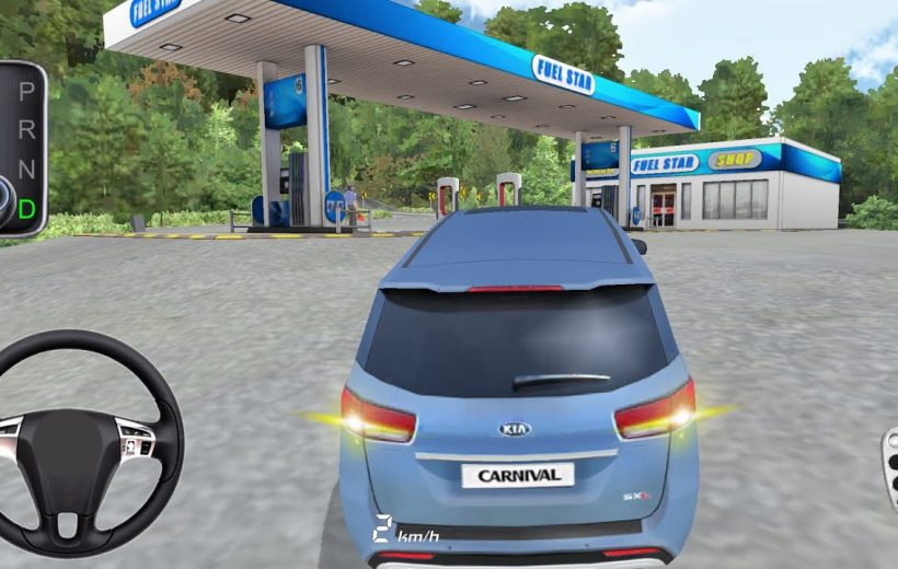 Blue Kia Carnival stopped at a fuel station with dashboard controls visible.