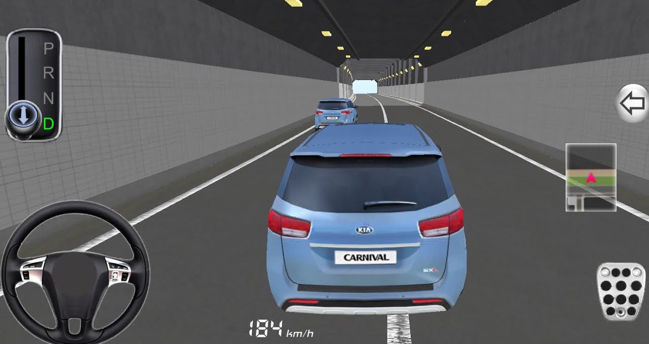 Blue Kia Carnival SUV driving behind another car through a lit road tunnel.