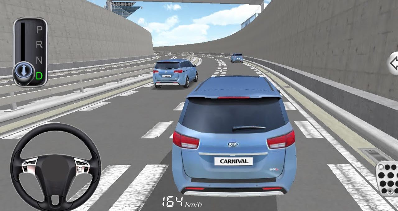 Rear view of a blue Kia Carnival driving along a multi-lane highway tunnel