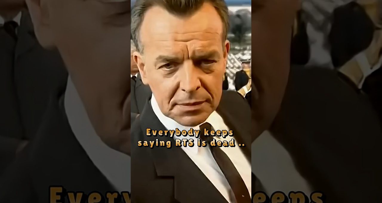 Serious middle-aged man in a black suit and tie looking directly at the camera