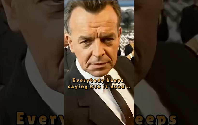 Serious middle-aged man in a black suit and tie looking directly at the camera