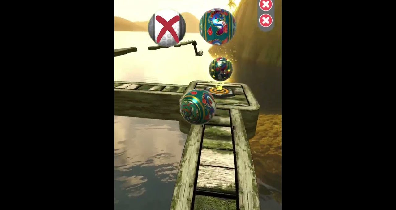 Colorful decorative ball rolling along a narrow wooden plank path over water