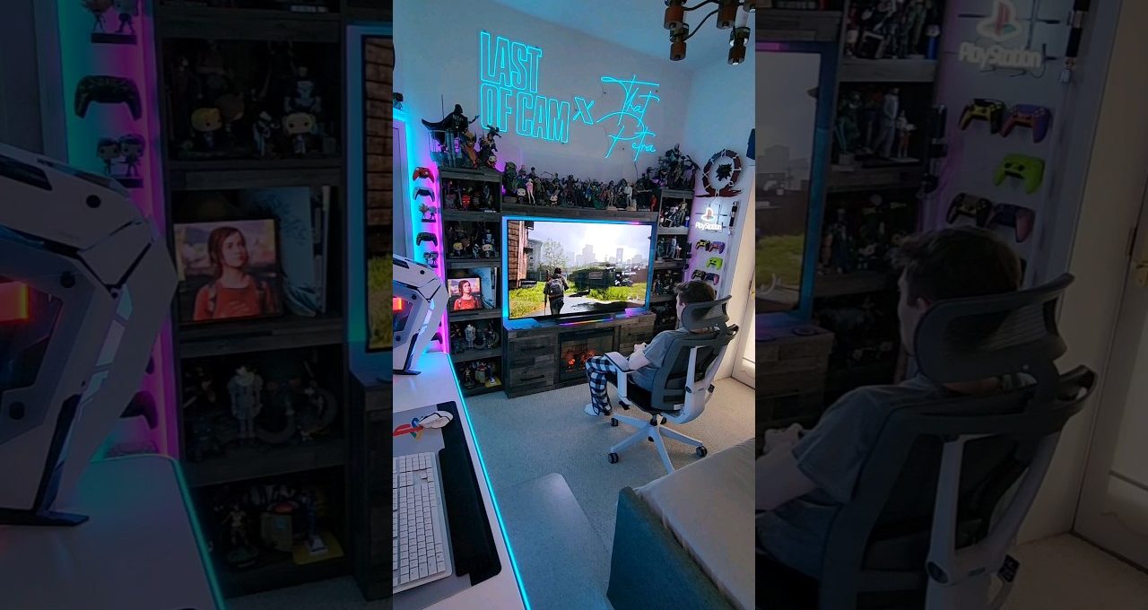 Person seated in gaming chair watching a large TV in RGB-lit gaming room