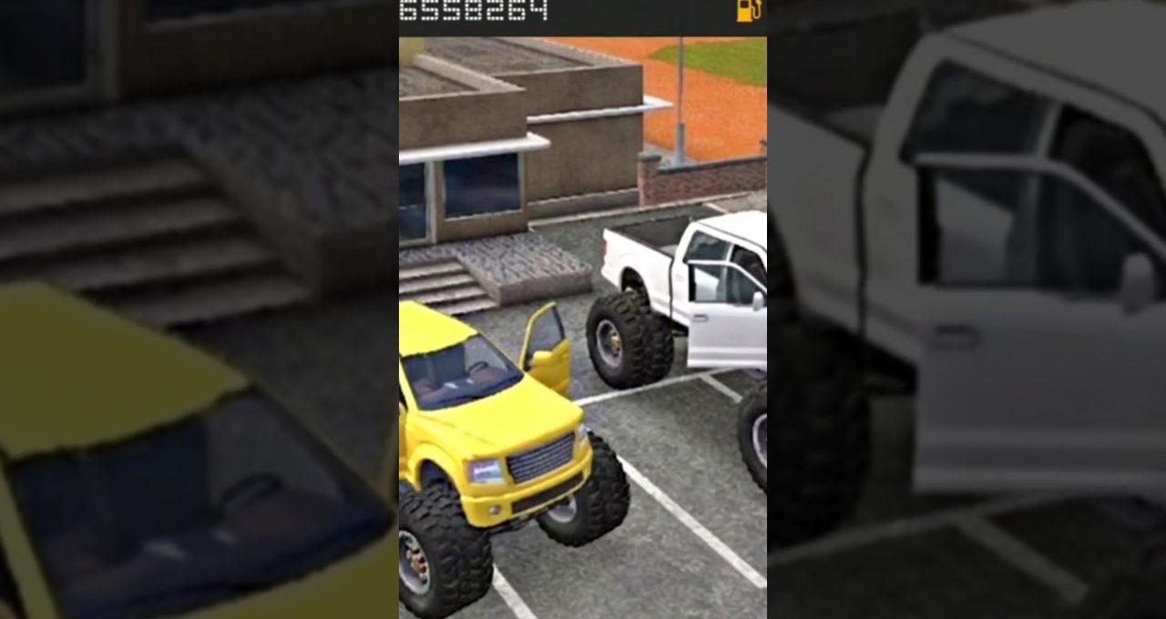 Two lifted monster trucks, one yellow and one white, parked with doors open