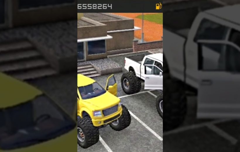 Two lifted monster trucks, one yellow and one white, parked with doors open
